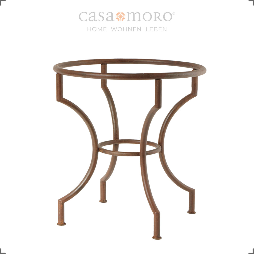 Round dining table with curved wrought iron frame in a patina look