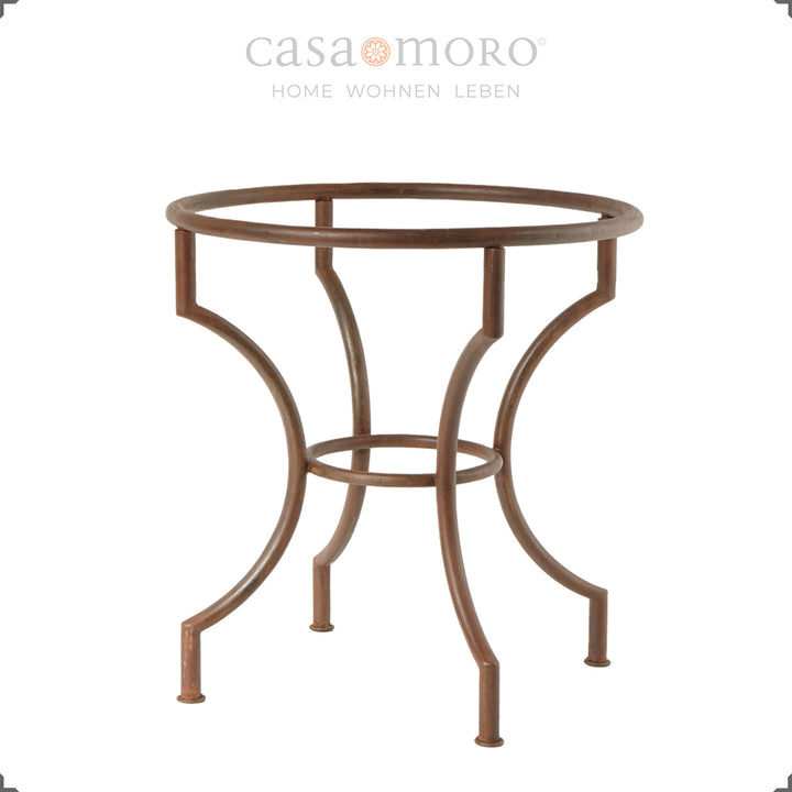 Round dining table with curved wrought iron frame in a patina look