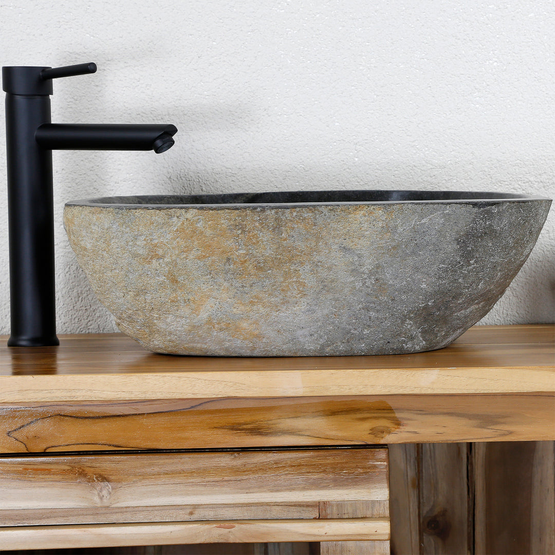 Countertop stone washbasin - river stone on a wooden washbasin, combined with a black stand-alone tap