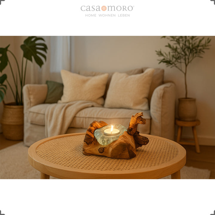 Tealight holder made of glass and burl wood on a round coffee table, its warm light complements the bright, natural living room ambience.