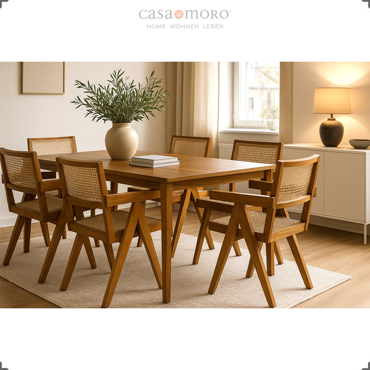 Dining room with solid teak table and matching armchairs with Viennese wicker, warm ambience in natural tones
