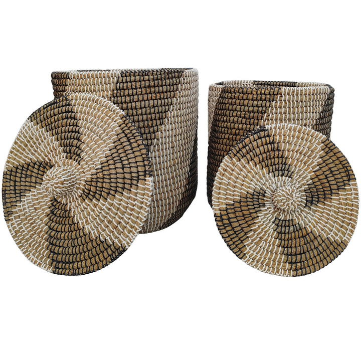 Woven seagrass baskets, approx. 40 and 65 litres, with black/white patterned lids leaning in front.