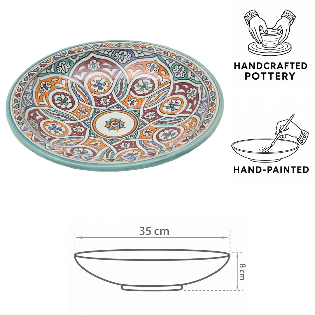 Hand-painted Moroccan ceramic bowl with a circular pattern in turquoise, orange, and burgundy, 35 cm in diameter and 8 cm high