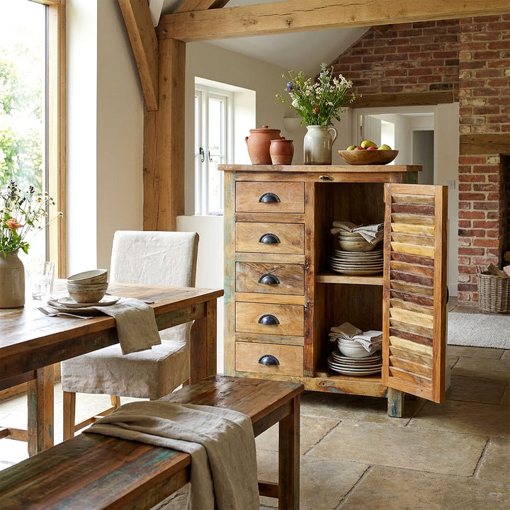 Solid wood highboard in dining room with opened doors, dishes in interior, natural vintage home scene