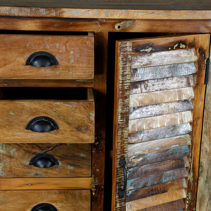 Detailed view of a highboard made of solid wood with a drawer front and a patchwork door
