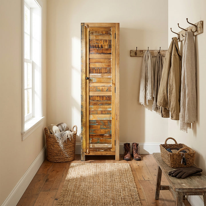 Narrow tall cabinet made of solid wood and reclaimed wood in vintage style, placed in the hallway