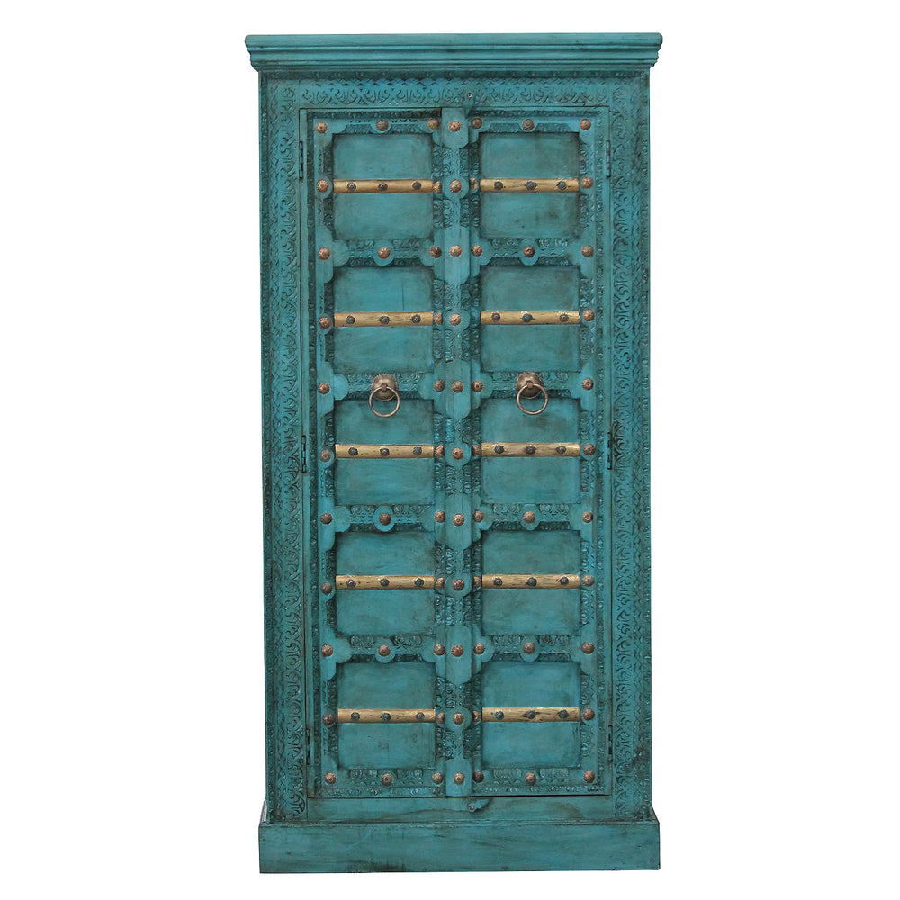 Front view of the turquoise mango wood cabinet, showing carved ornaments, gold-coloured trim and two doors.