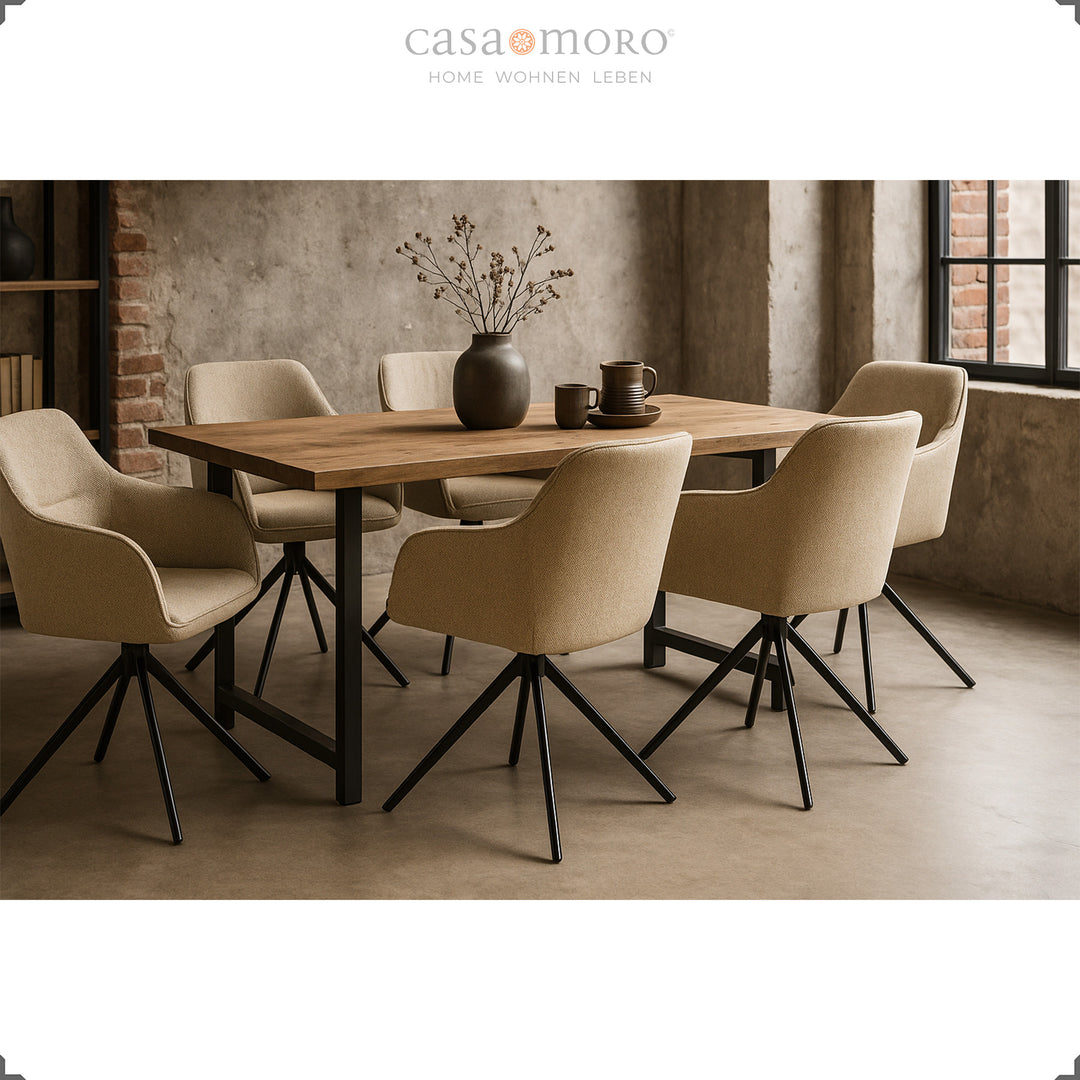 Six 360° swivel upholstered chairs with beige armrests around a wooden table in a modern dining room with concrete walls and a black metal frame