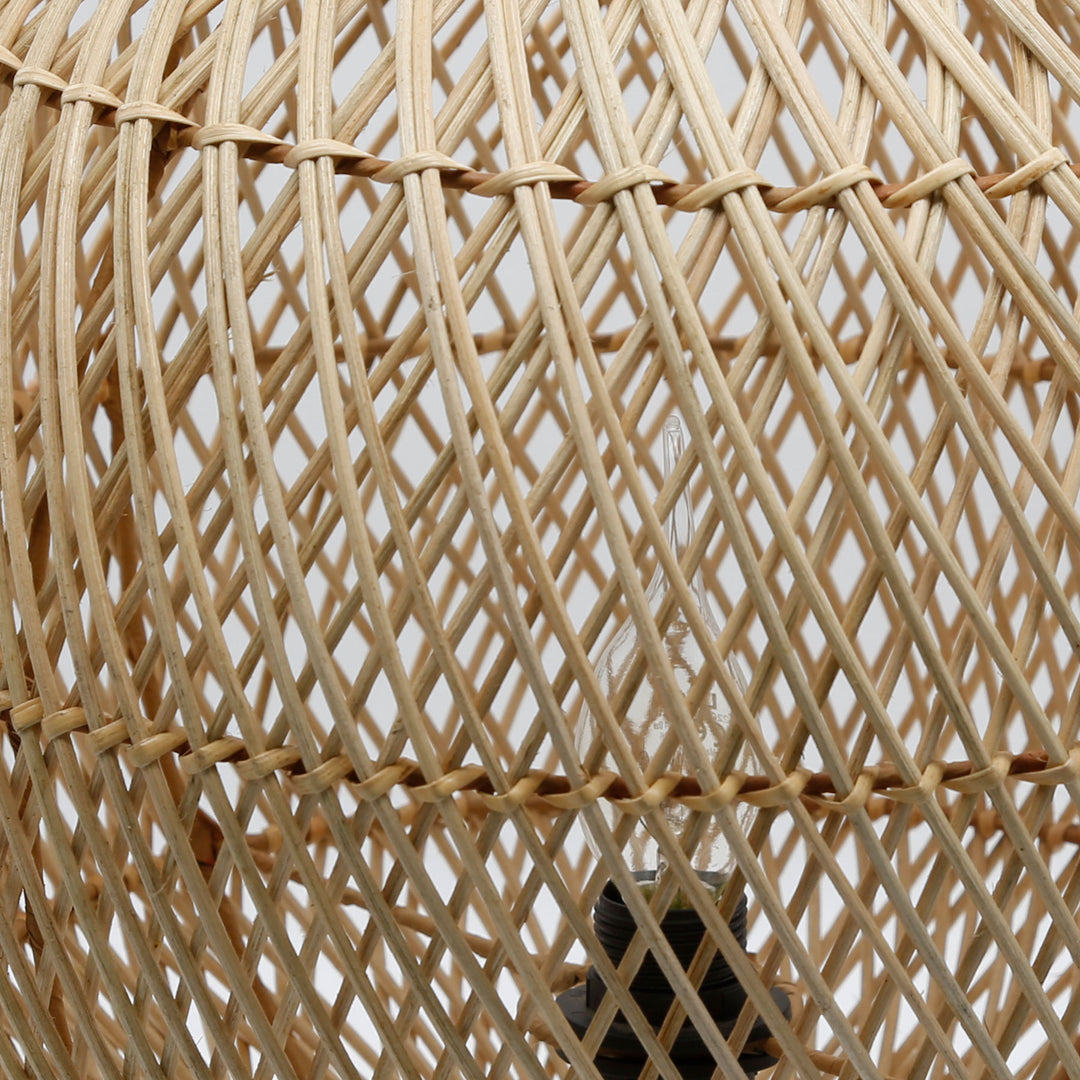Detailed shot of the rattan lamp with a fine weave pattern and visible light bulb inside