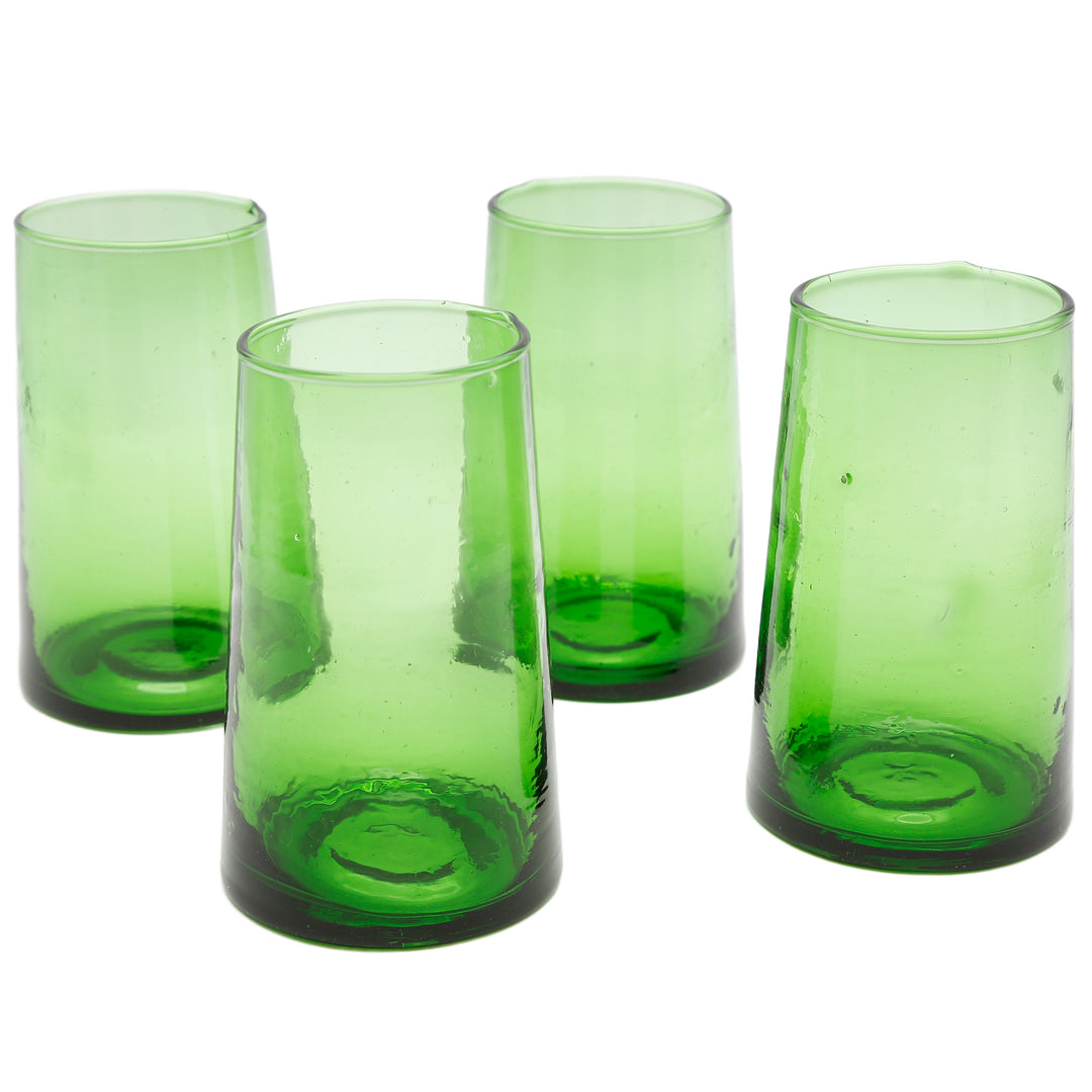 Four green long drink glasses on a light surface - handmade, slightly irregular, stable