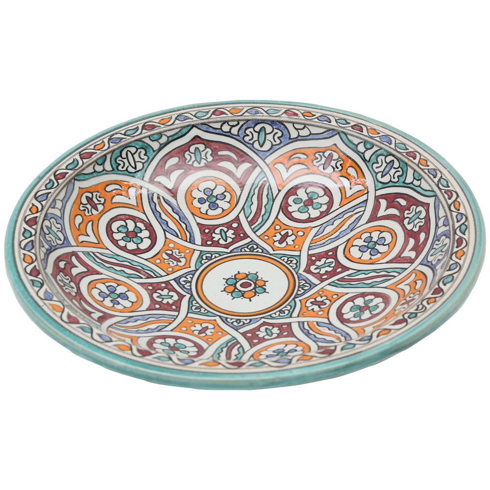 Hand-painted ceramic bowl with an intertwined circular pattern in turquoise, orange, and burgundy