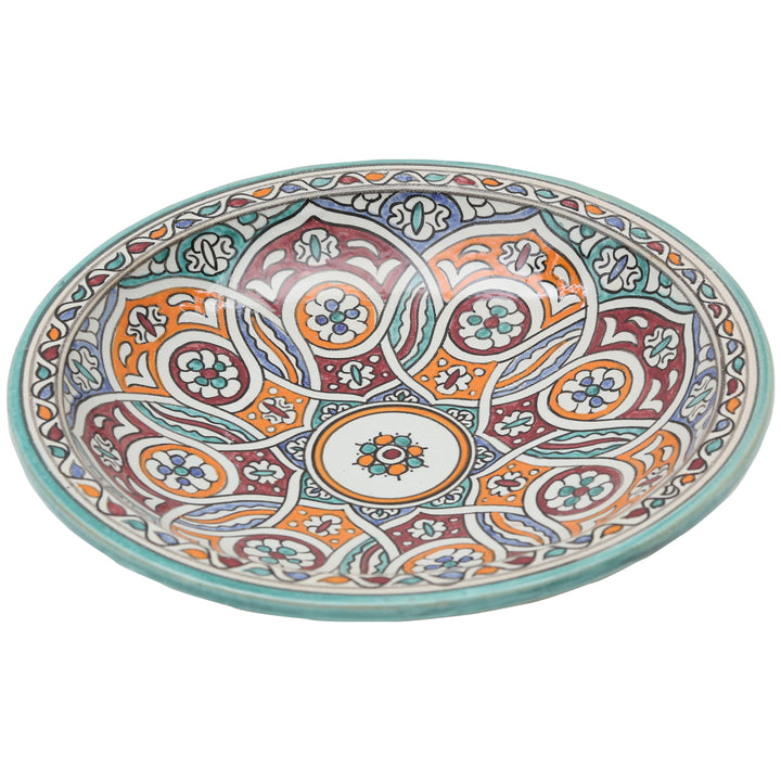 Hand-painted ceramic bowl with an intertwined circular pattern in turquoise, orange, and burgundy