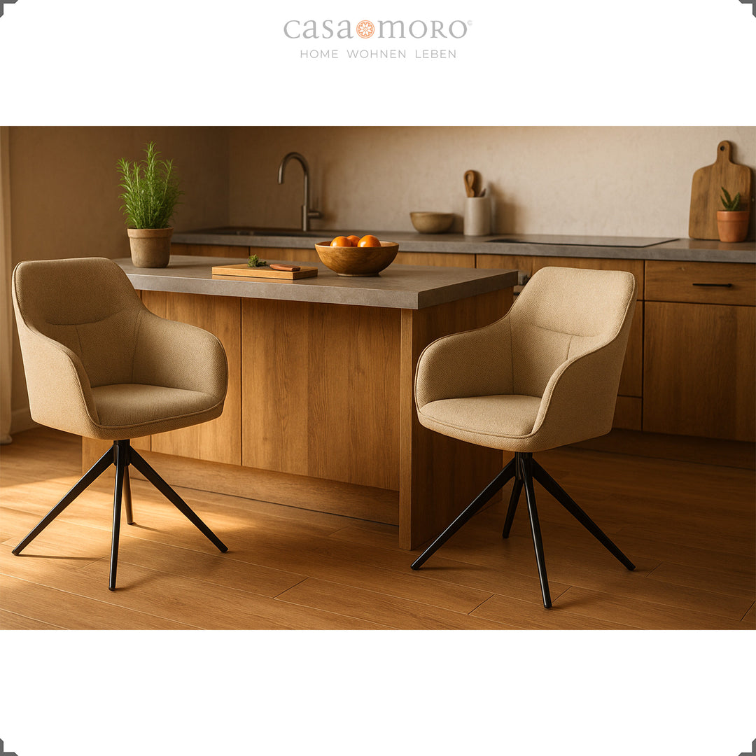Two 360° rotating upholstered chairs with armrests in beige in front of a wooden kitchen island, warm light emphasizes the modern and cozy style