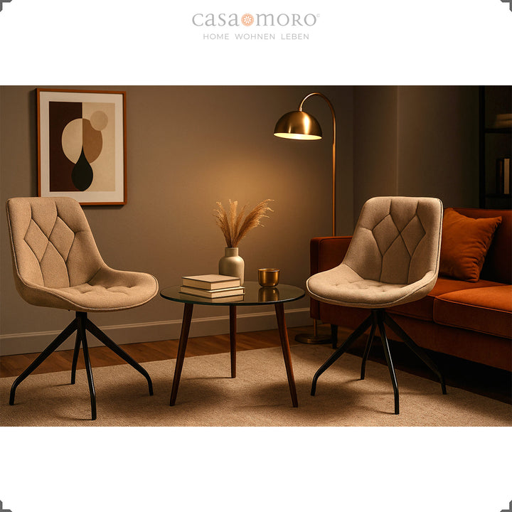 Two upholstered chairs that can be rotated 360° in brown with a black metal frame - a cozy seating area with a side table and warm light in the modern living room