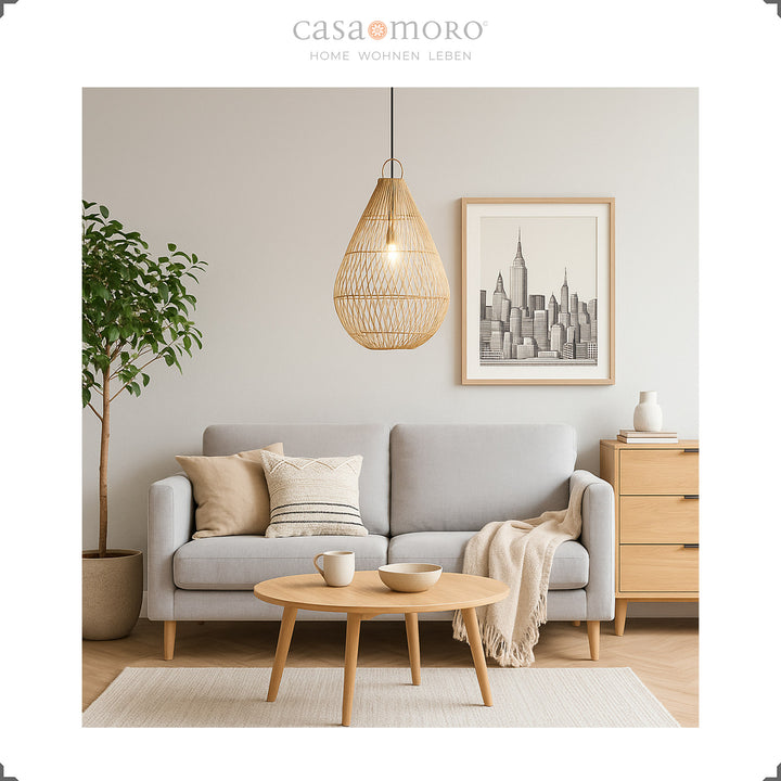 Handmade rattan lamp in teardrop shape as a hanging lamp in the living room, providing warm light and natural elegance