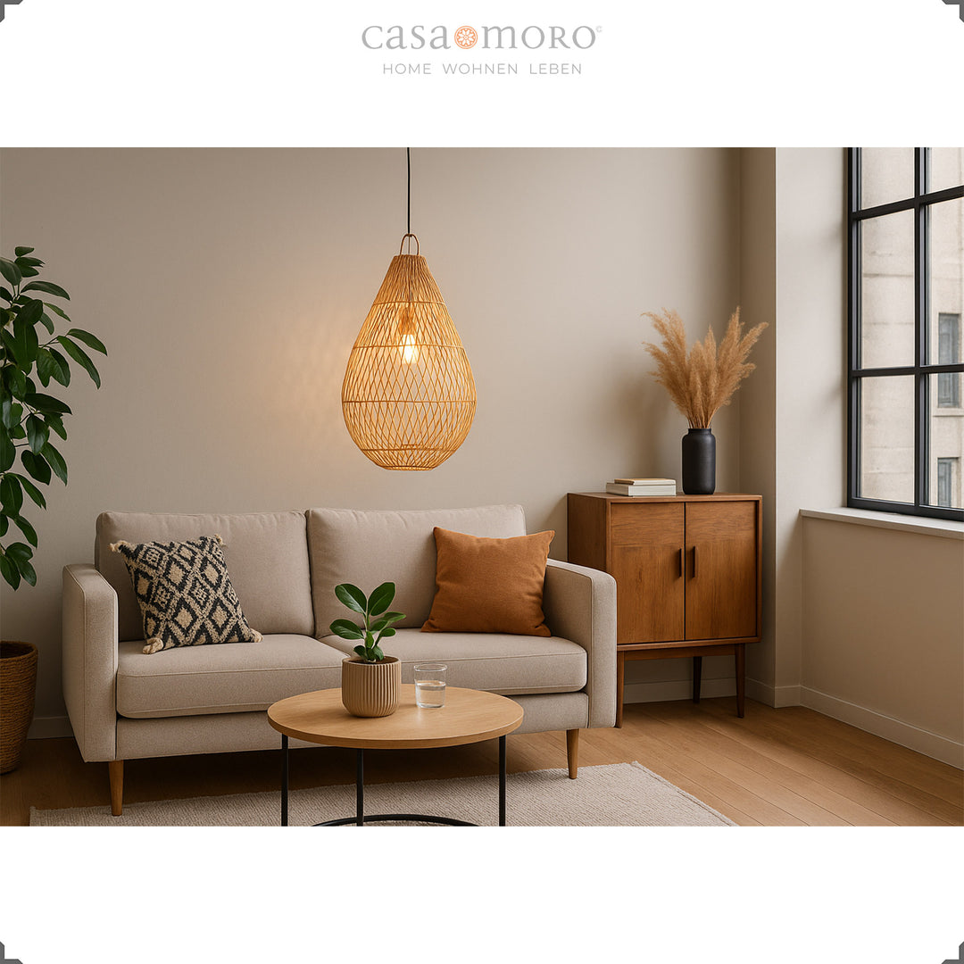 Rattan lamp in teardrop shape as a hanging lamp in the living room, creates warm light and natural cosiness