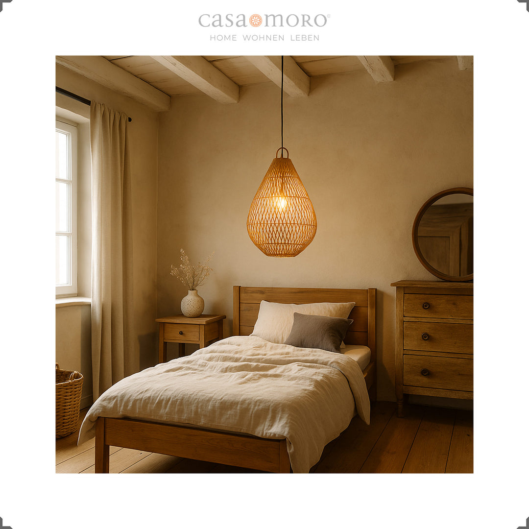 Rattan lamp in teardrop shape as a ceiling light in the bedroom, providing warm light and natural calm
