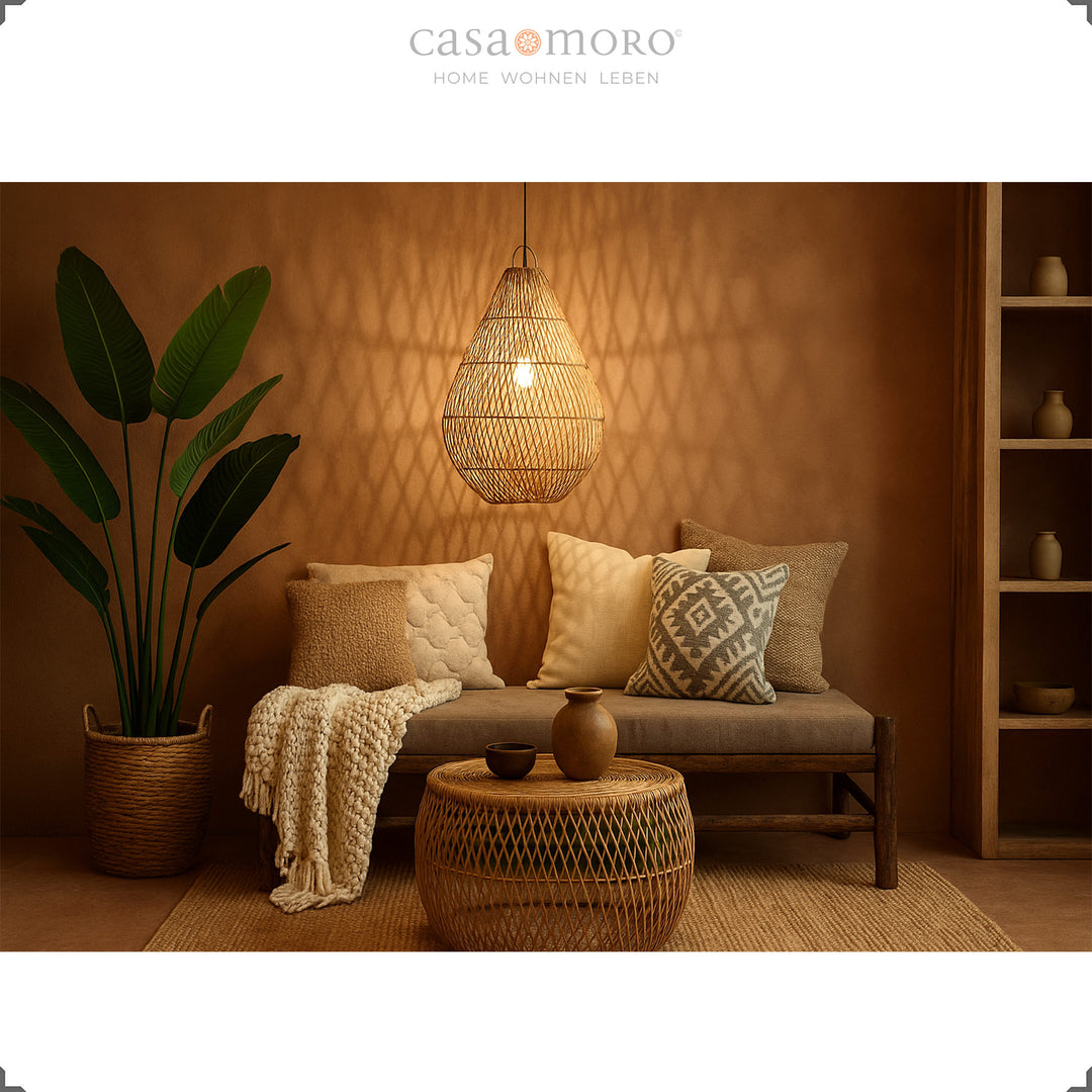 Rattan lamp in teardrop shape as a hanging lamp in the living room, creates warm light and a cozy boho atmosphere