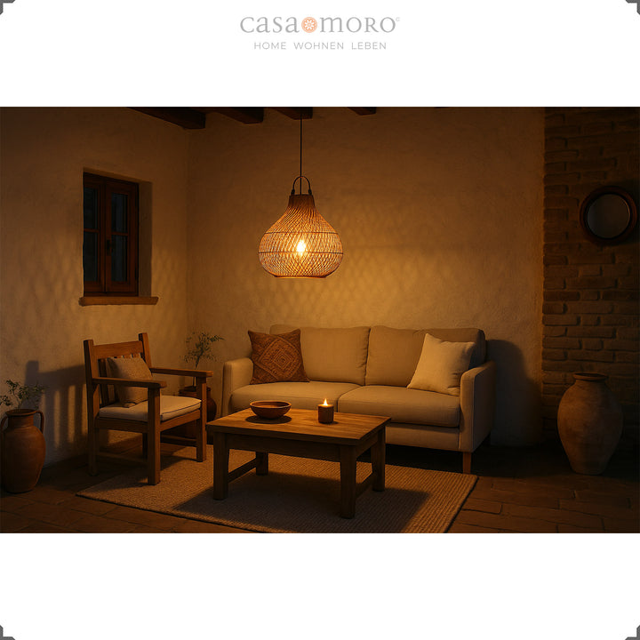 Rattan lamp above sofa in Mediterranean living room, warm light and cozy evening atmosphere