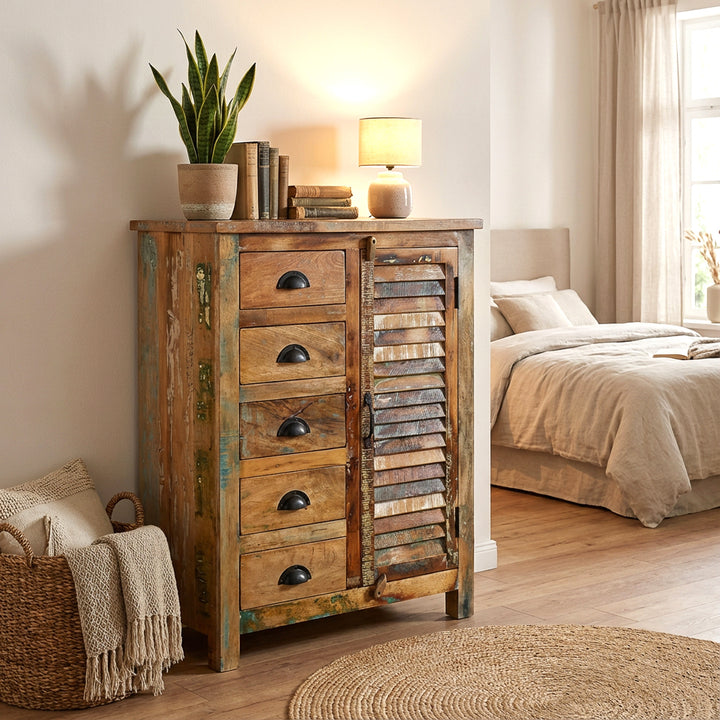Highboard made of solid old wood in the bedroom, natural textiles, warm light