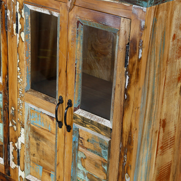 Detailed view of a sideboard made of reclaimed wood with glass doors and patchwork wood