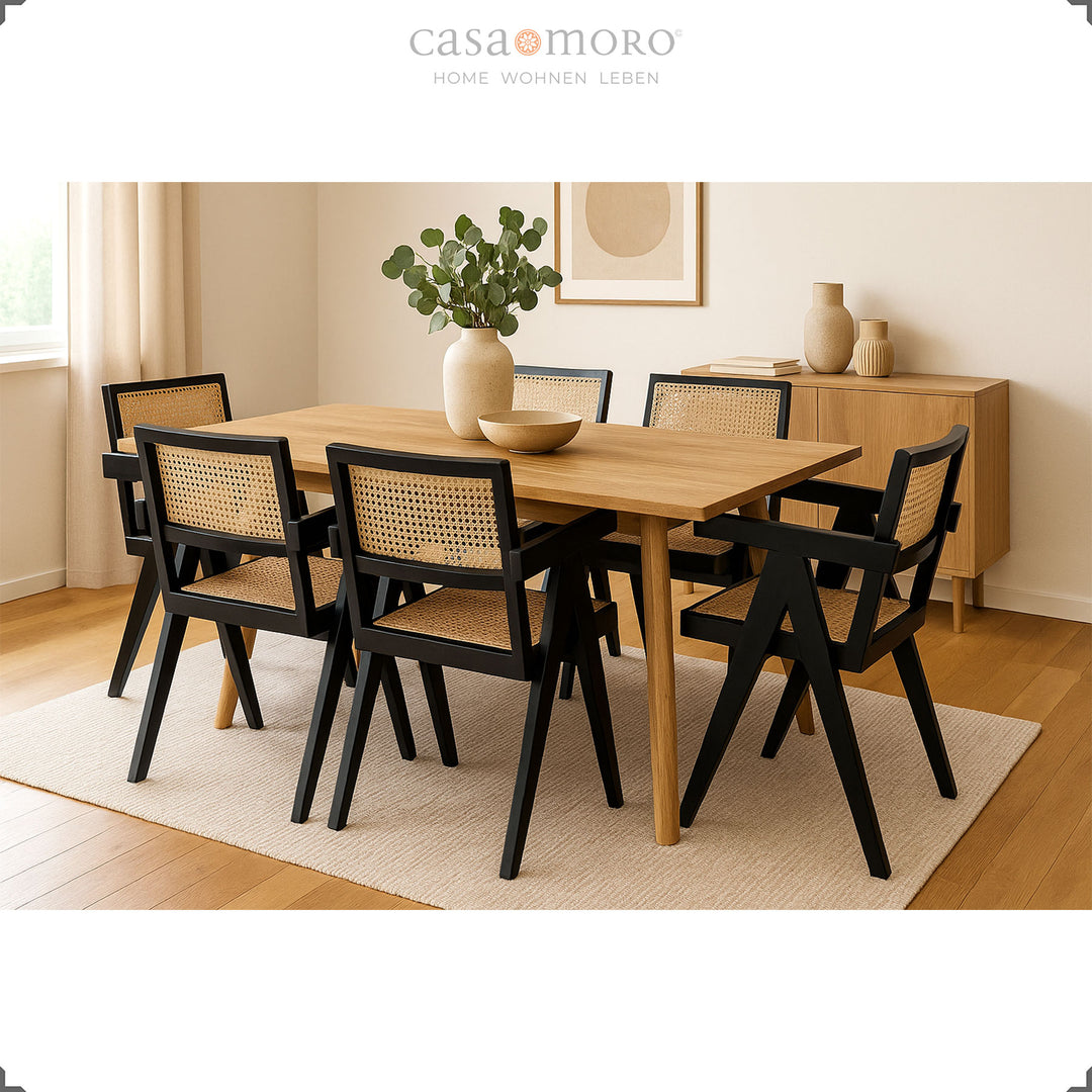 Modern dining group with black armchairs made of teak and Viennese wicker, combined with a light wooden table