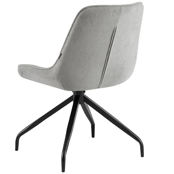 Gray dining chair with 360° swivel function and black metal frame - cozy reading corner with side table, blanket and warm light