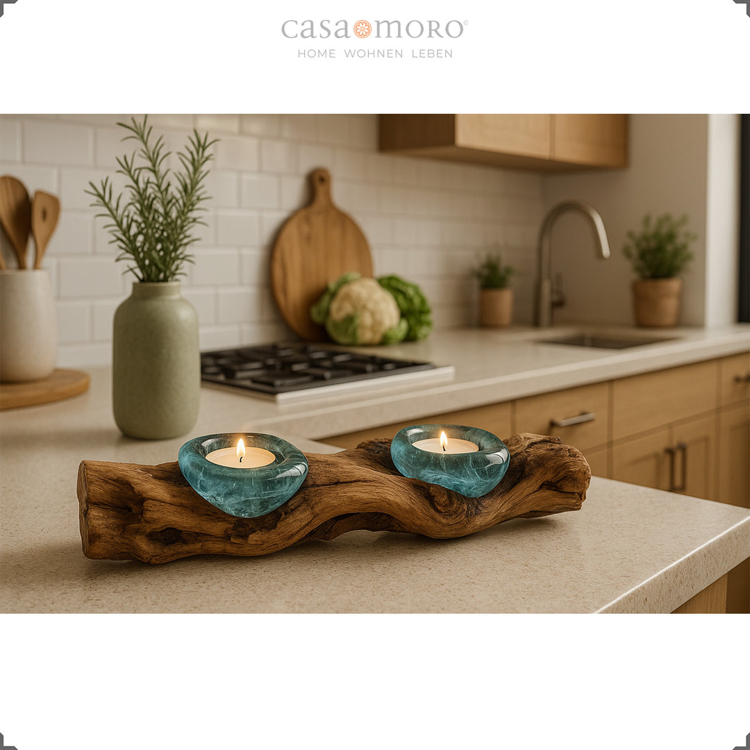 2 tea light holders made of glass and burl wood on a kitchen worktop, its warm light creates a natural, calm accent.