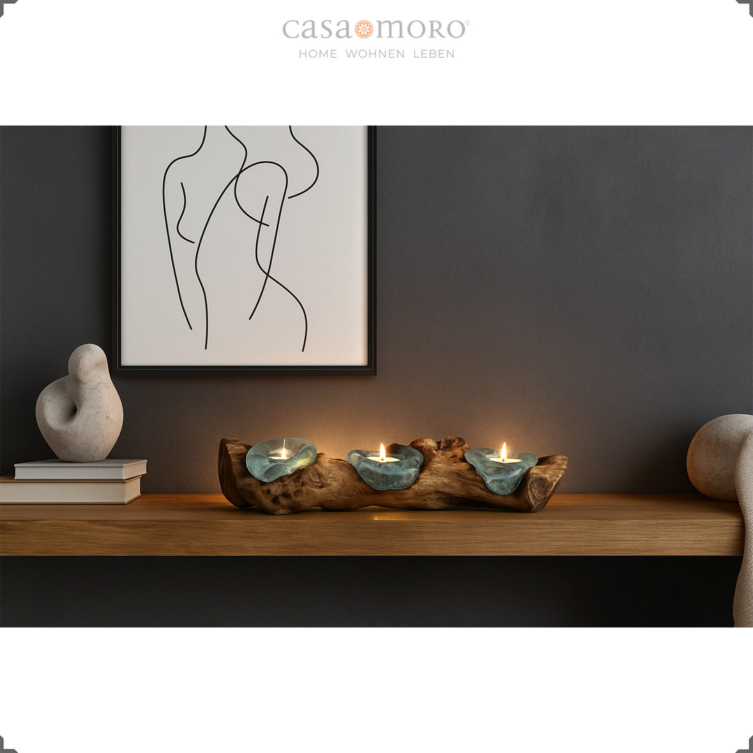 Three-part tea light holder made of glass and burl wood on a wall shelf