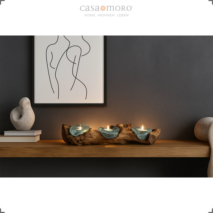 Three-part tea light holder made of glass and burl wood on a wall shelf