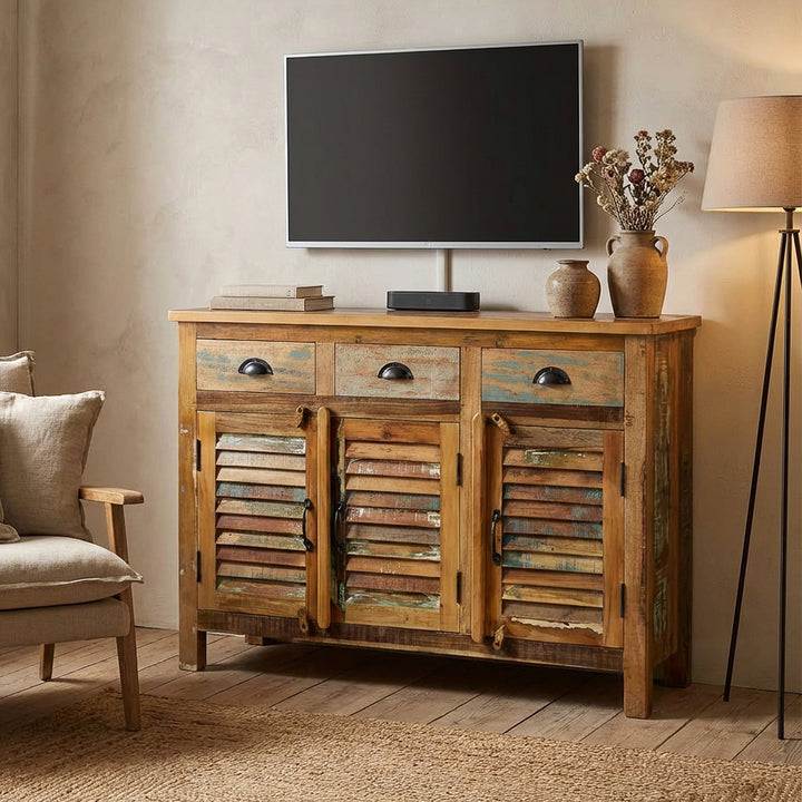 Vintage highboard made of solid wood and old wood with drawers placed as TV furniture in the living room