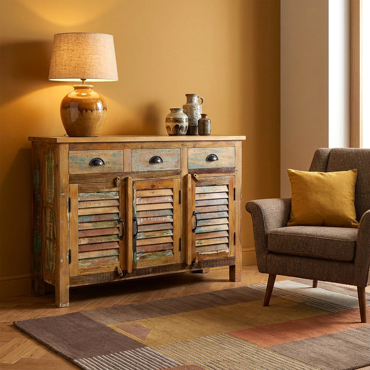 Solid wood and reclaimed wood highboard with vintage style drawers, placed in modern living room