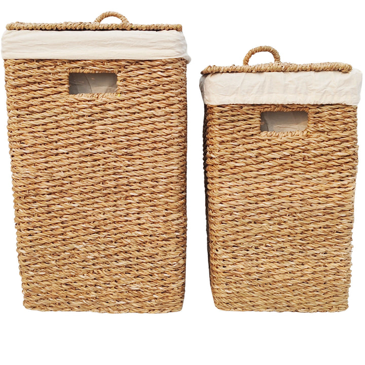 Seagrass laundry basket set with capacities of 50 and 90 liters, featuring closed lids, handle openings, and light-colored fabric inserts.