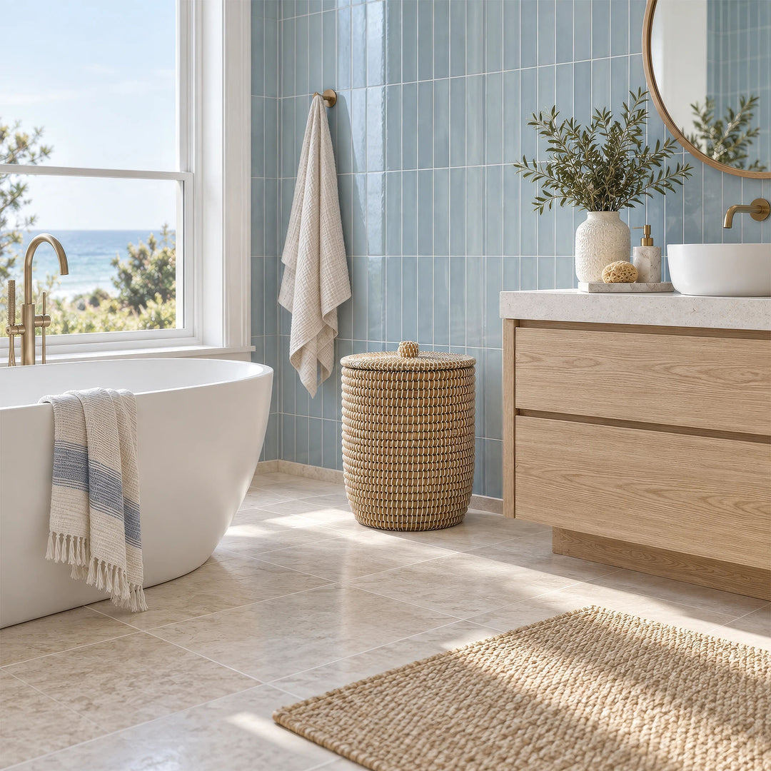 Natural/white seagrass laundry basket with lid, approximately 40 litres, between the bath and vanity unit.