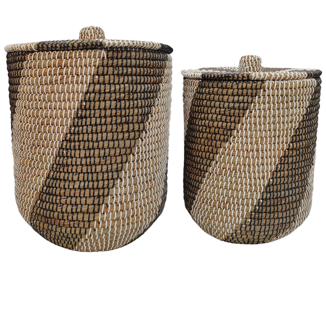 Two natural/black/white seagrass laundry baskets with closed lids, approximately 40 and 65 litres.