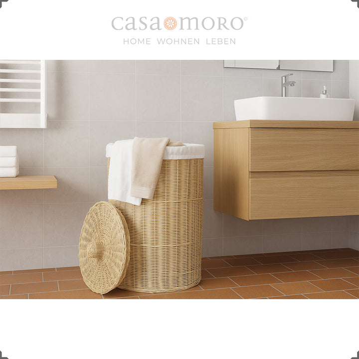 Stylish woven rattan laundry basket in modern bathroom with bright interior