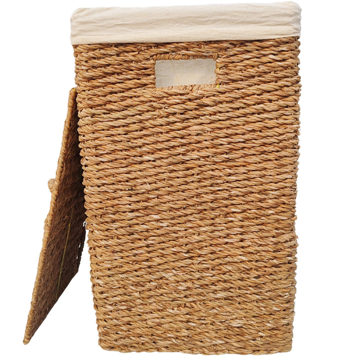 Rectangular laundry basket made of seagrass with a 90-liter capacity, a light-colored fabric liner, and a lid that rests against the side.