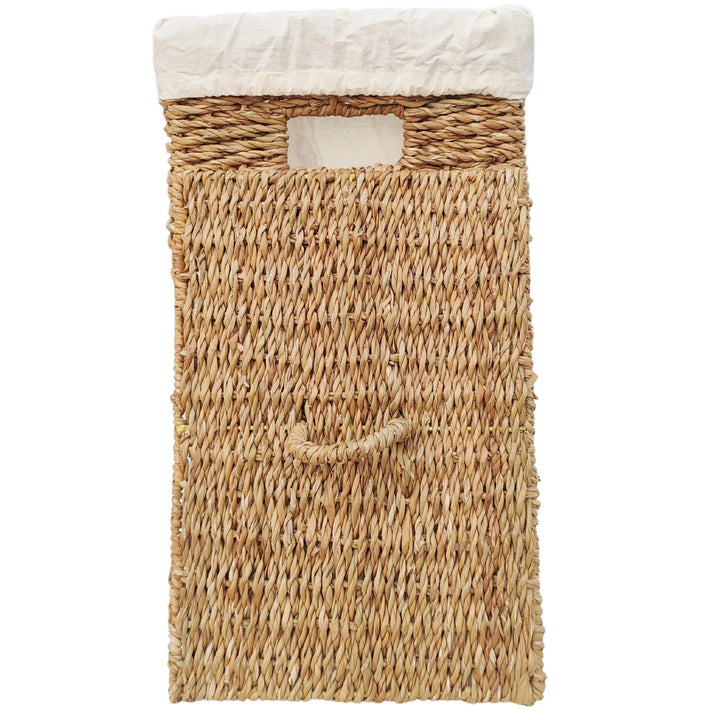 Rectangular laundry basket made of seagrass with a 50-liter capacity, a light-colored fabric liner, and a lid that rests against the front with a handle.