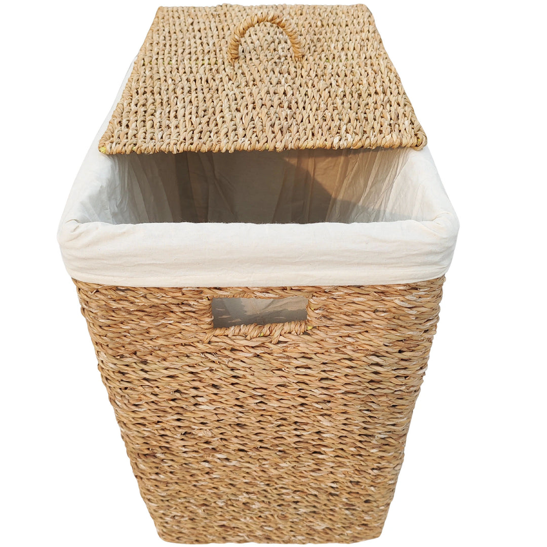 Rectangular laundry basket made of seagrass with a 90-liter capacity, a light-colored fabric liner, and a slanted lid.