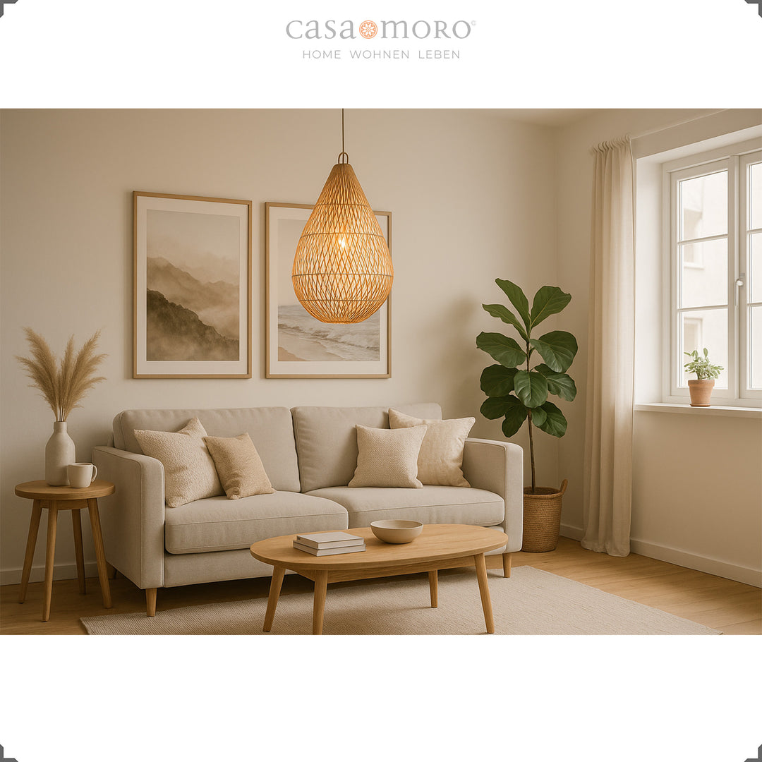 Handmade rattan lamp in teardrop shape as a hanging lamp in the living room, providing warm light and natural elegance