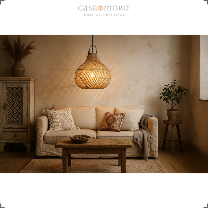 Rattan lamp above sofa in living room with rustic charm and warm play of light